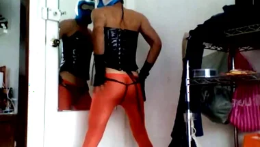Masked Sissy Boy in Orange Stockings and Corset Cums in Its Heels