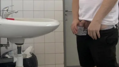 Guy Taking a Urine Sample in Hospital Toilets