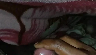 Big Boss massaging penis oil under the blanket
