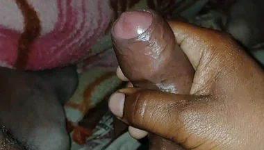 Big Boss massaging penis oil under the blanket