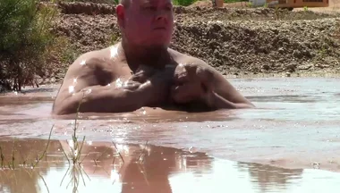 Deep, Creamy Brown Mud Bath in a Sand Pit
