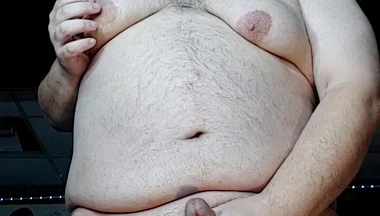 Chubby Guy Stands and Cums
