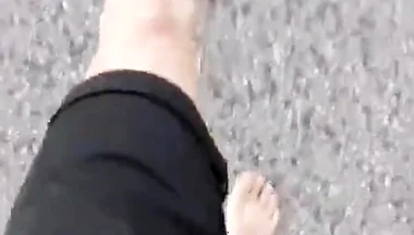 Jon Arteen Walks Barefoot on the Street Outdoors, the Boy Is Barefoot in the Crowded Tram to the Town Center