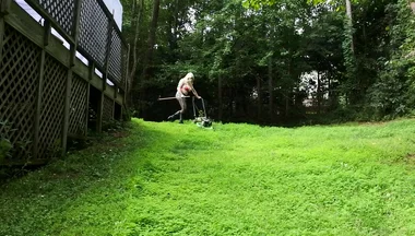 Big Fake Tits Crossdresser in Daisy Dukes Mowing Grass