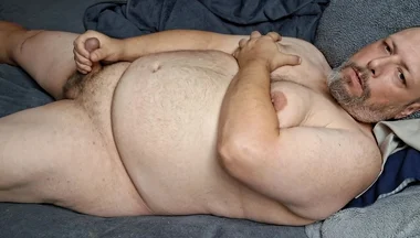 Chubby Guy Lays in Bed and Cums