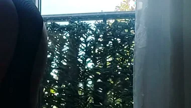 In Lingerie and Heels at the Window with a Toy