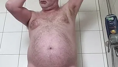 Fat Man Shaving Hair on His Head